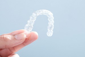 Closeup of patient holding clear aligner