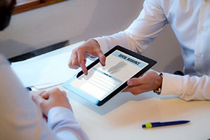 Patient looking at dental insurance form on tablet
