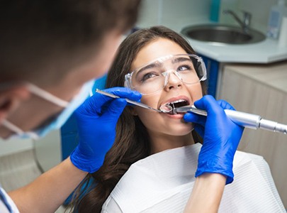 Dentist cleaning a patient’s teeth